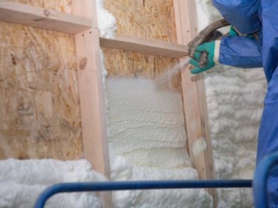 Foam is applied to the walls to warm the house at construction