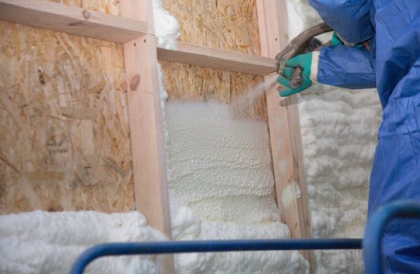 Foam is applied to the walls to warm the house at construction