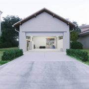 Open door of a modern garage with a concrete driveway at the urban district.