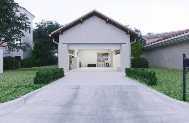 Open door of a modern garage with a concrete driveway at the urban district.
