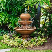 Fountain in green garden with walkway in thailand