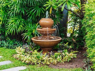 Fountain in green garden with walkway in thailand