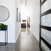Contemporary home entry hall with polished concrete floors