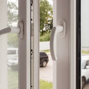 Handles of opened white plastic window indoor closeup