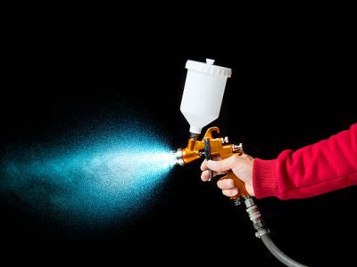 Airbrush paint sprayer isolated on black