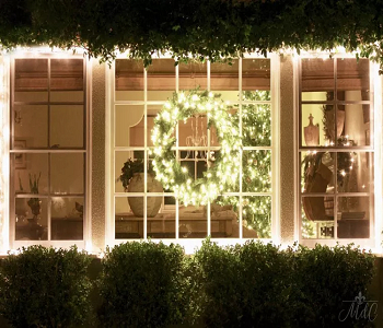 A wreath on the windows Illuminating The Outside Of Home With Gorgeous Christmas Light Ideas