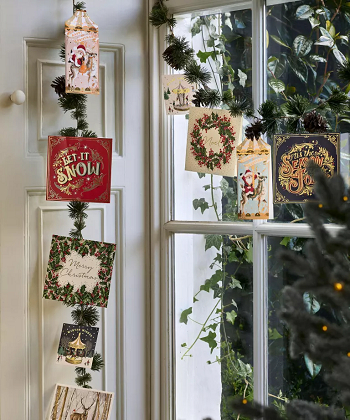 Hang it together with garland How To Have Creative Christmas Card Display Ideas This Year