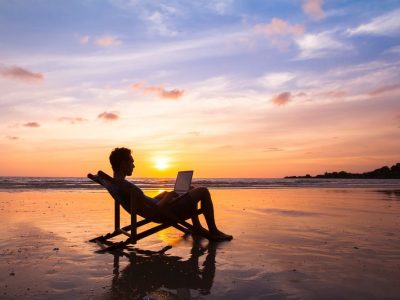 Silhouette,of,happy,business,man,with,laptop,working,on,the