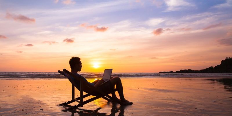 Silhouette,of,happy,business,man,with,laptop,working,on,the
