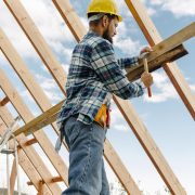 Construction-worker-with-hard-hat-building-roof-house