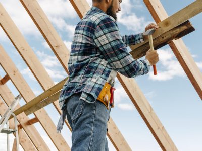 Construction-worker-with-hard-hat-building-roof-house