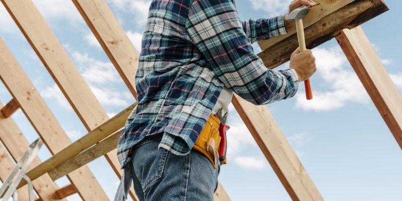 Construction-worker-with-hard-hat-building-roof-house