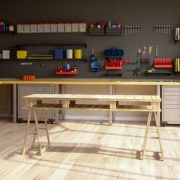 Workshop interior with tools, working equipments and wooden working table.