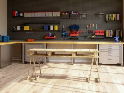 Workshop interior with tools, working equipments and wooden working table.