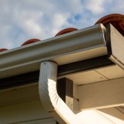 House with new seamless aluminum rain gutters downpipe