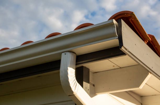 House with new seamless aluminum rain gutters downpipe