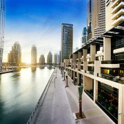 Skyline of dubai marina at night with boats, united arab emirates, middle east