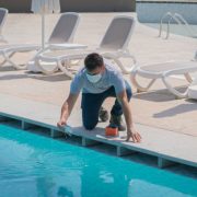 Pool testing kit being used in a swimming pool