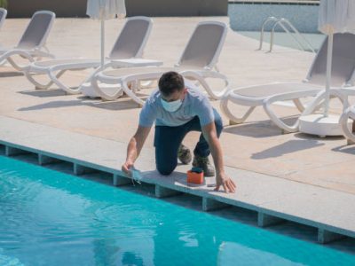 Pool testing kit being used in a swimming pool