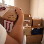Close up shot of a man carrying a moving box