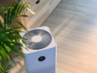 Air purifier on wooden floor in comfortable home. fresh air and healthy life.