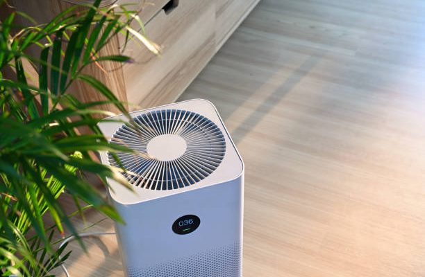 Air purifier on wooden floor in comfortable home. fresh air and healthy life.