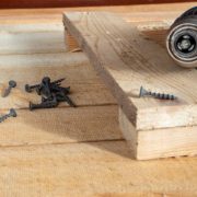 Self-tapping screws and a drill-screwdriver on wooden boards. home life, diy