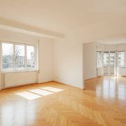Interior of a modern empty apartment with big windows