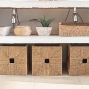 Details of a modern cozy white interior, with several wicker boxes
