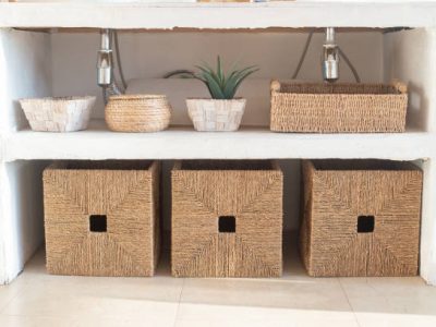 Details of a modern cozy white interior, with several wicker boxes