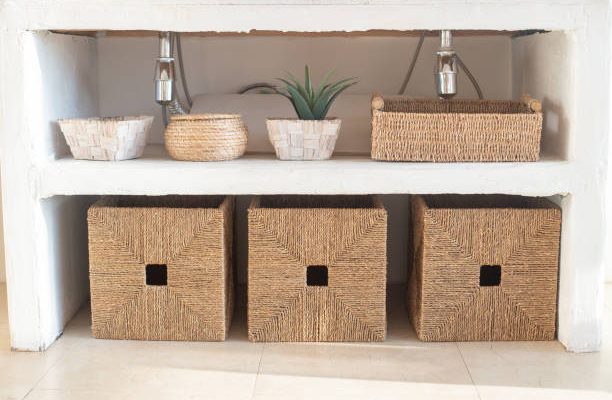 Details of a modern cozy white interior, with several wicker boxes