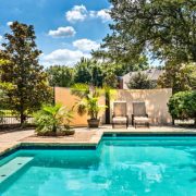Backyard oasis with a swimming pool inside a private residential backyard