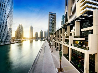 Skyline of dubai marina at night with boats, united arab emirates, middle east