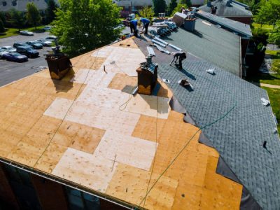 Roof repairs old roof replacement with new shingles of an apartment building