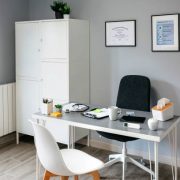 Interior of empty doctor's office with table and cupboard