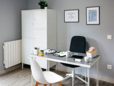 Interior of empty doctor's office with table and cupboard