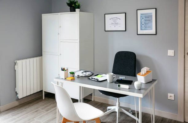 Interior of empty doctor's office with table and cupboard