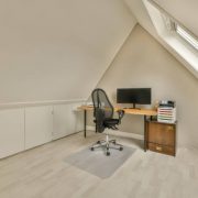 Working area on the top floor of a modern house with a computer on the table