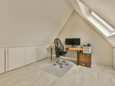 Working area on the top floor of a modern house with a computer on the table