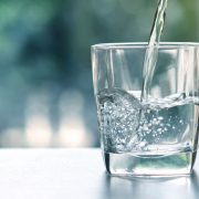 Close up the pouring purified fresh drink water from the bottle
