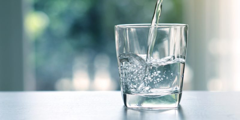 Close up the pouring purified fresh drink water from the bottle