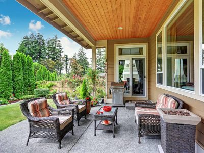Cozy covered sitting area with wicker chairs and barbecue. northwest, usa