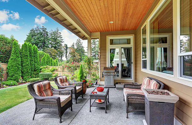 Cozy covered sitting area with wicker chairs and barbecue. northwest, usa