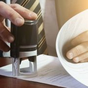 The businessman puts a stamp on the contract. copy space.