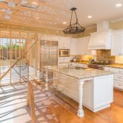 House construction framing gradating into finished kitchen build.