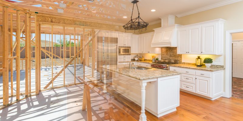 House construction framing gradating into finished kitchen build.