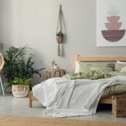 Stylish room interior with comfortable wooden bed