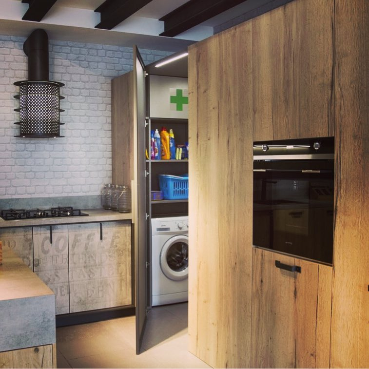 The laundry room is integrated with the kitchen. There is a wood door used for the room divider.