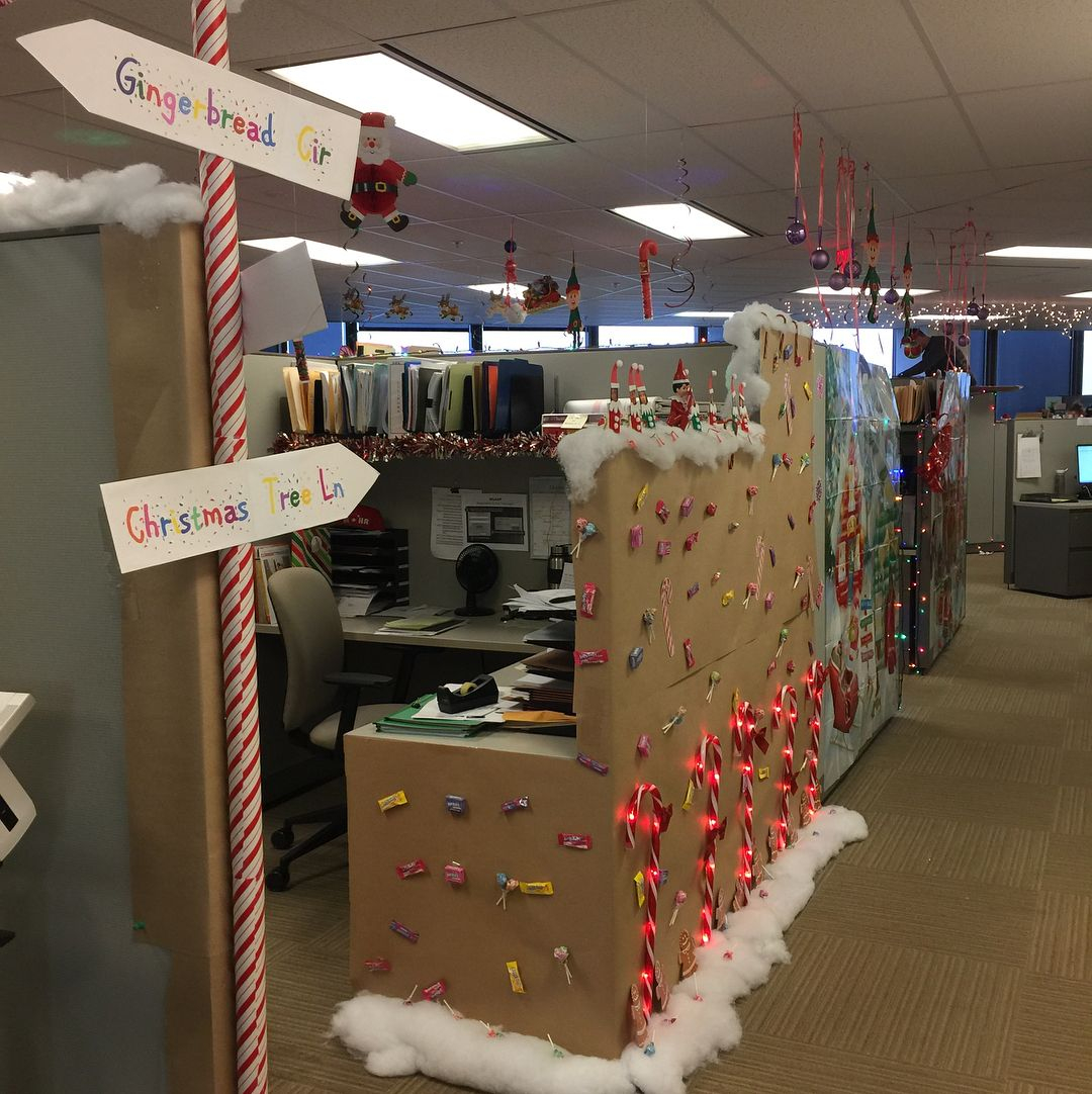 This office cubicle is wrapped in brown paper color then added with candy cane ornaments installed with fairy lights which is awesome.