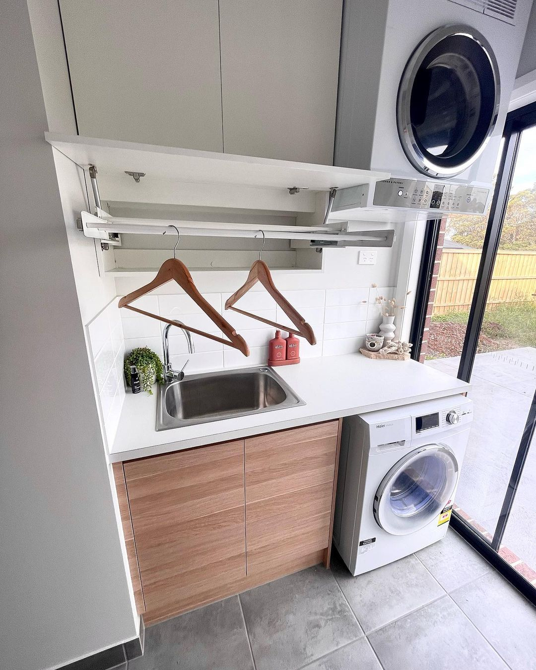 This one is an example of a small laundry room that has a drying rack.